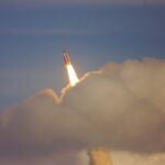 low-angle photography of red space shuttle
